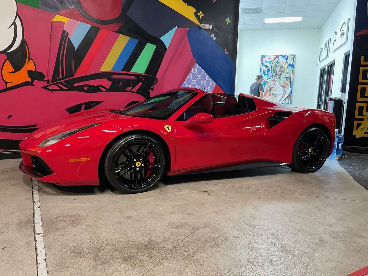 Red Ferrari 488 Spider with legal windshield tint strip and full ceramic window tint in Miami
