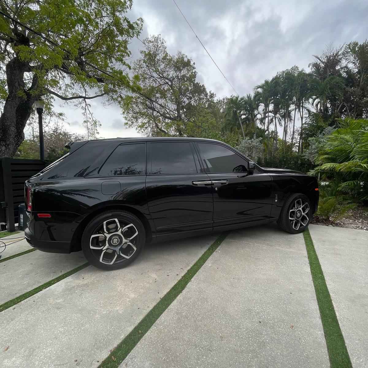 Luxury vehicle with mobile window tinting in South Florida driveway representing Shine Bright marine services