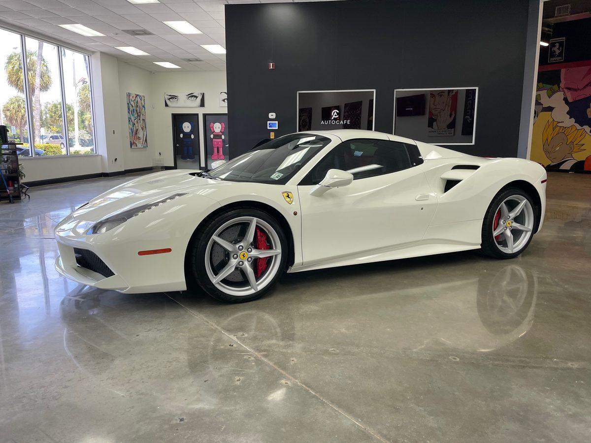 White Ferrari 488 with clean ceramic window tint showing proper post-install care